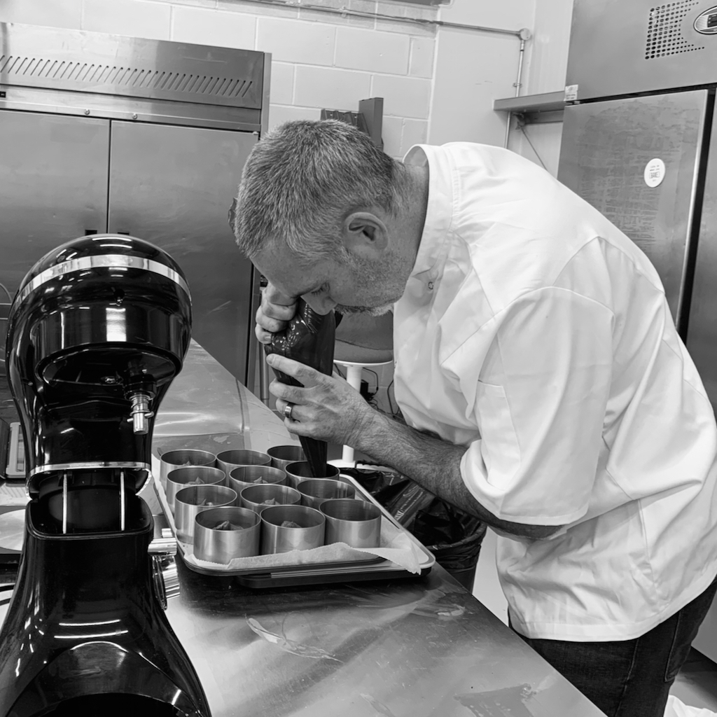 Dani piping chocolate into moulds